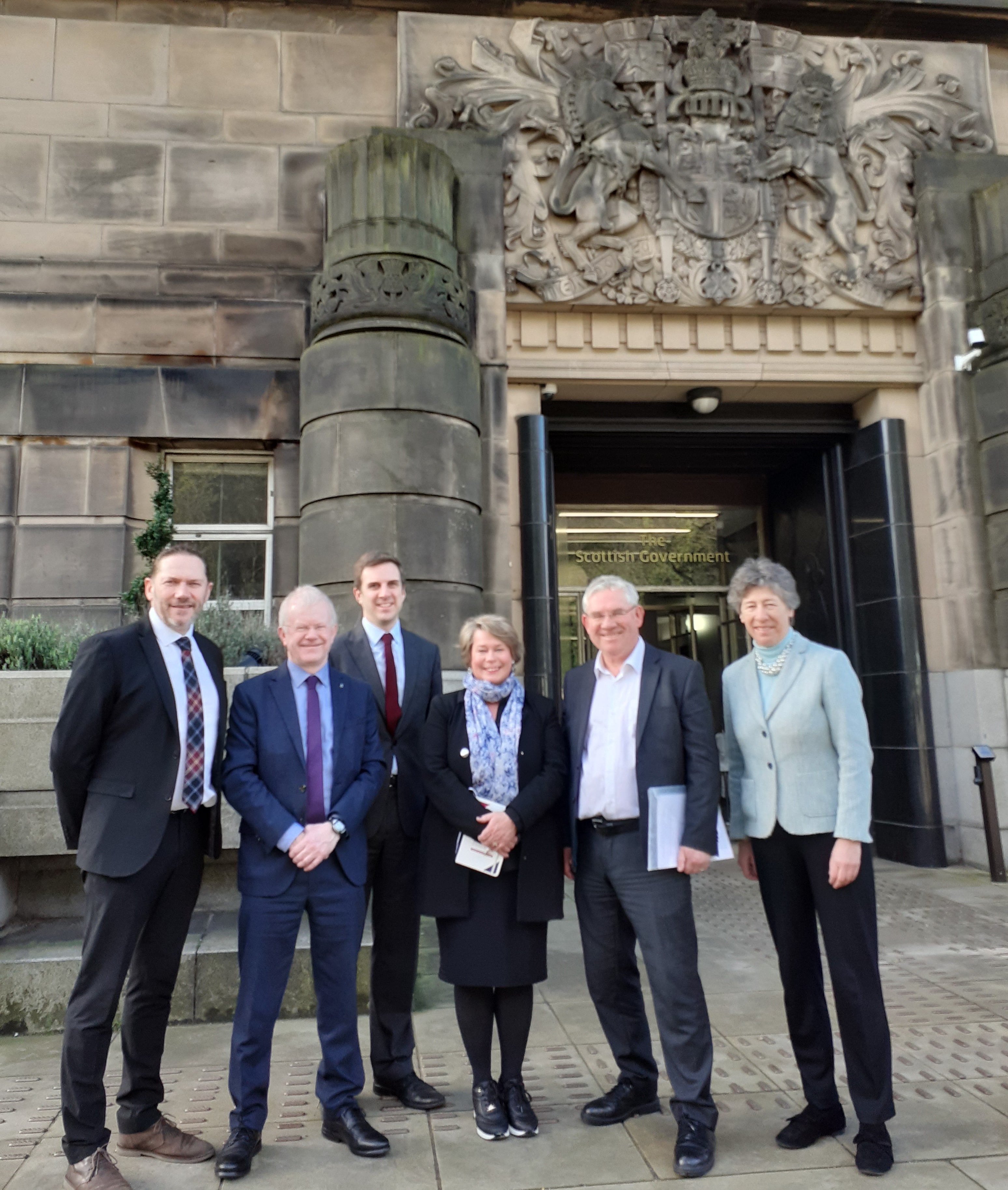 Photo of Members in front of St Andrew's House
